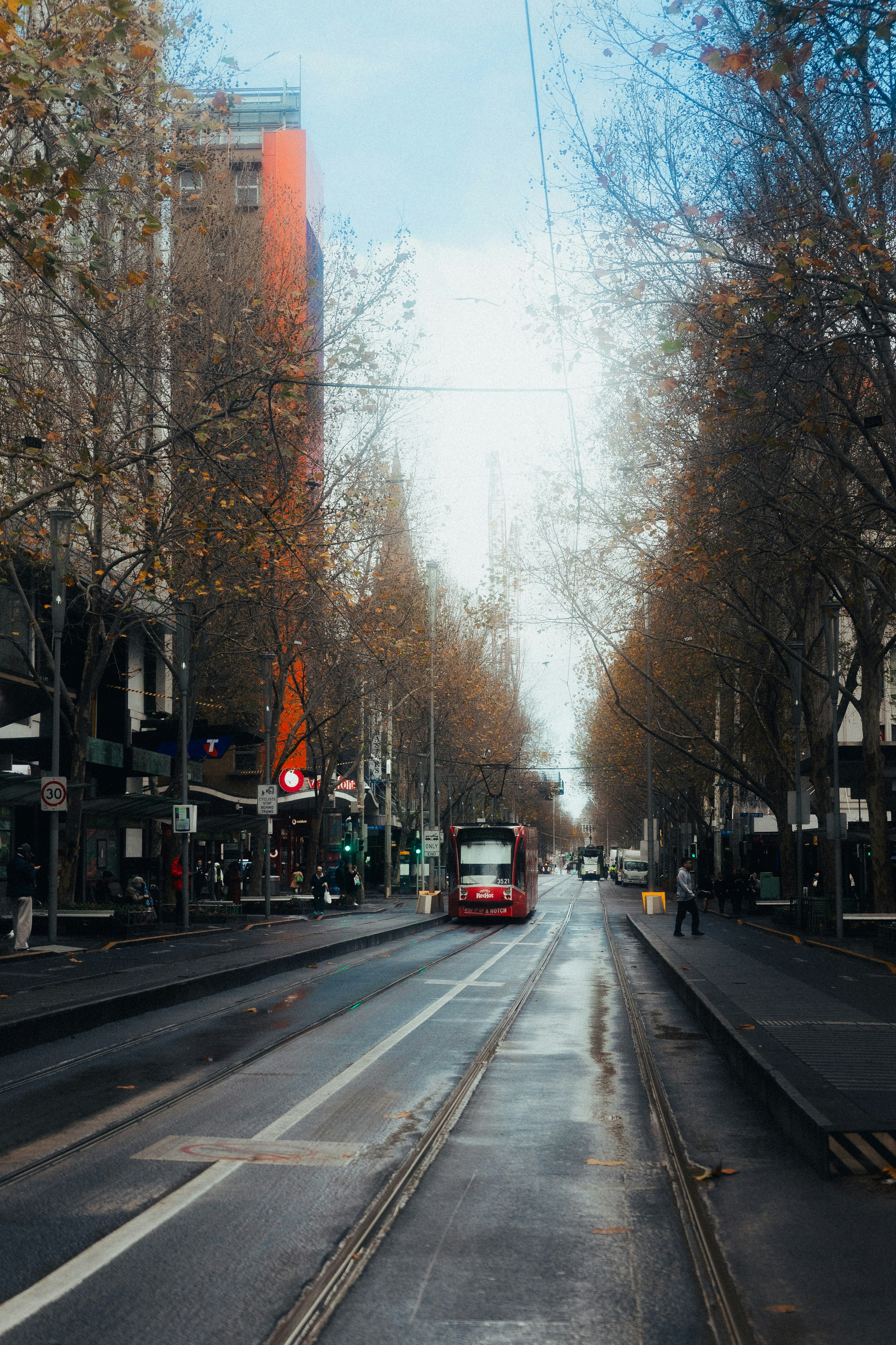 A car driving down a street next to tall buildings