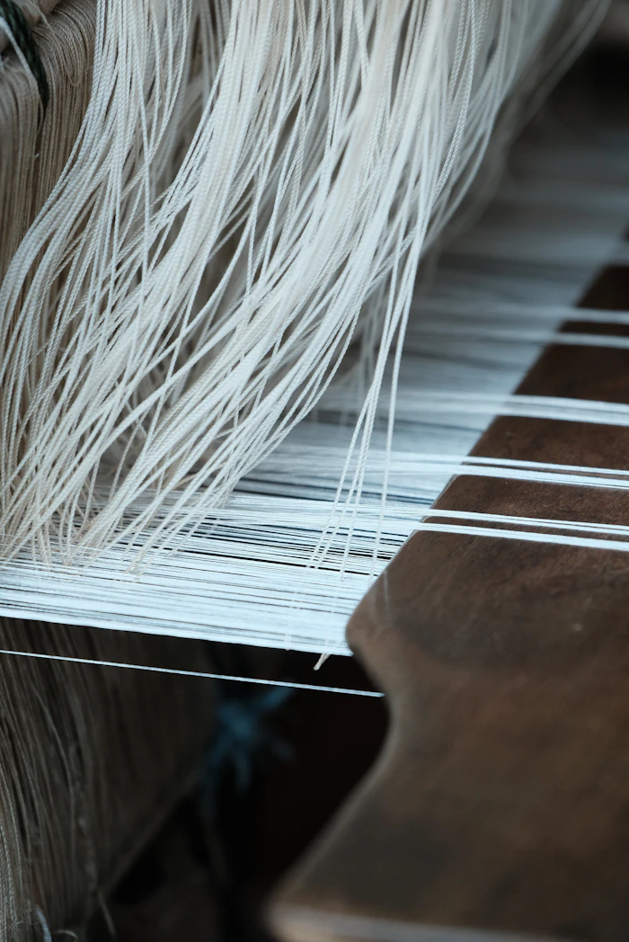 A close-up of a traditional weaving loom in use