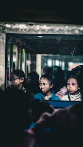 A group of people sitting on a bus