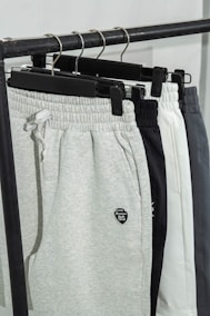 A pair of sweat pants hanging on a rack