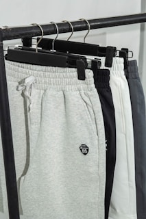 A pair of sweat pants hanging on a rack