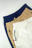 Three pairs of men's shorts on a white background