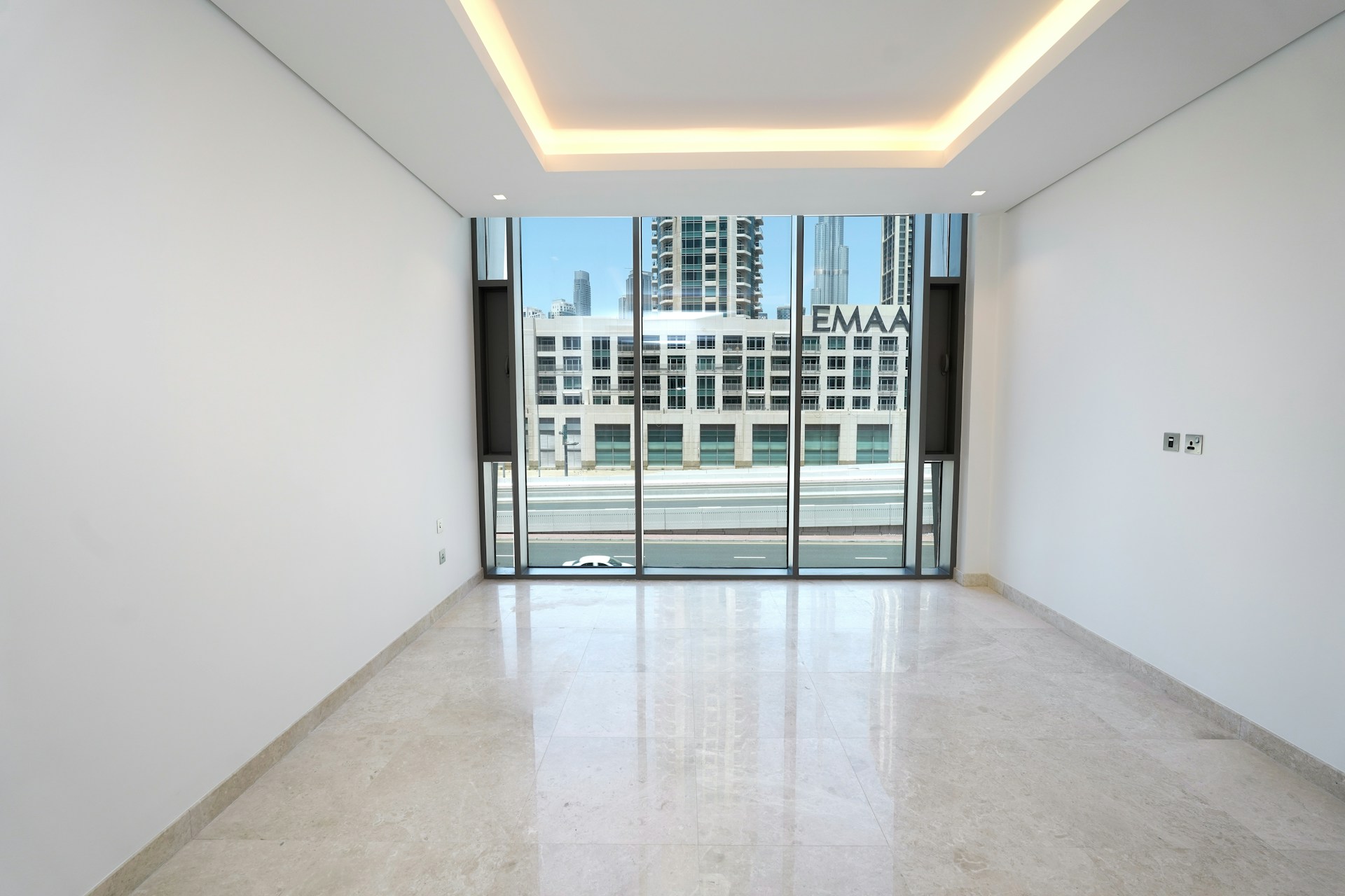 An empty room with a view of a city