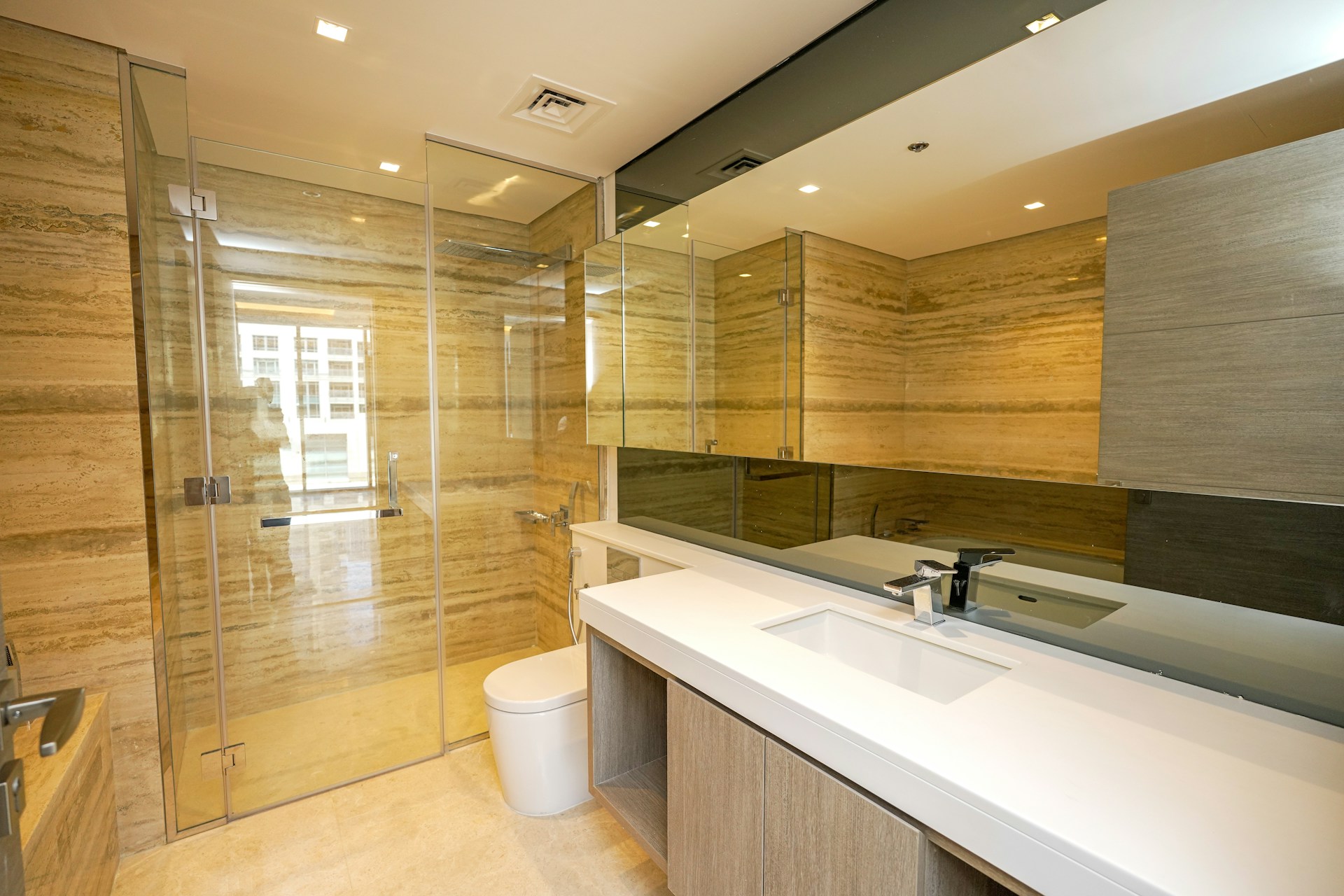 A bathroom with a large mirror and a sink