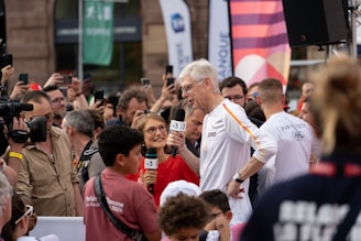 A crowd of people standing around each other