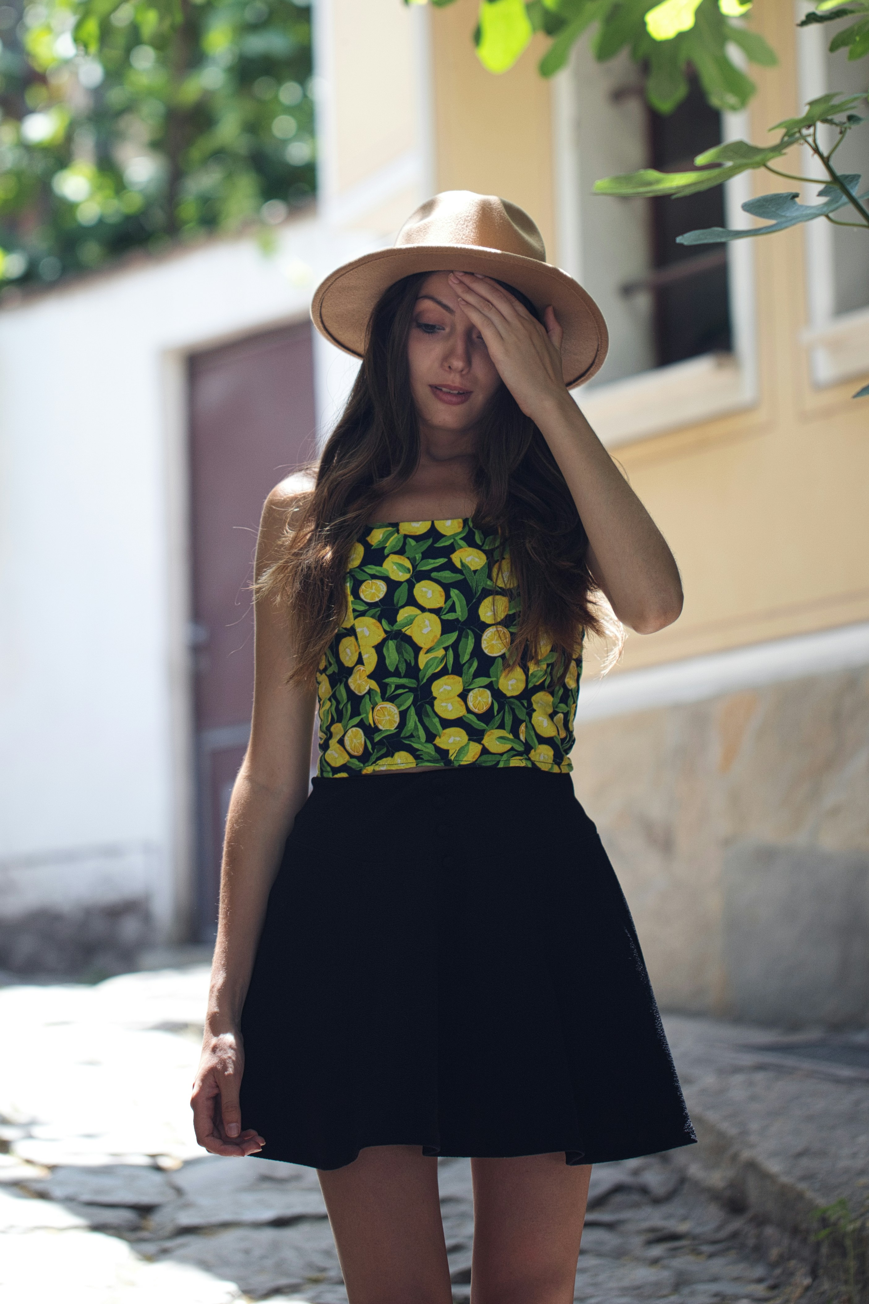 A woman wearing a hat and a dress