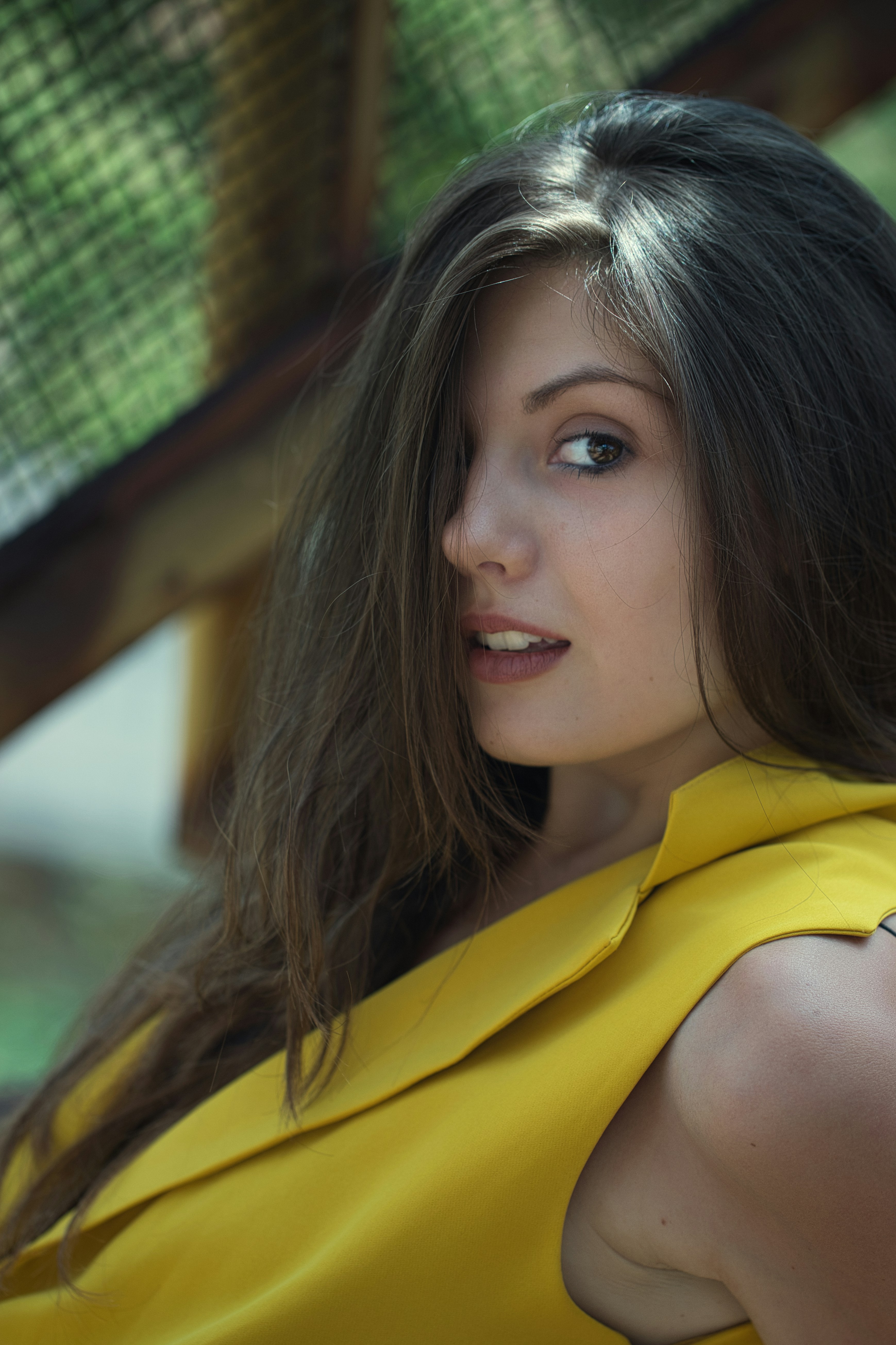 A woman in a yellow dress posing for a picture