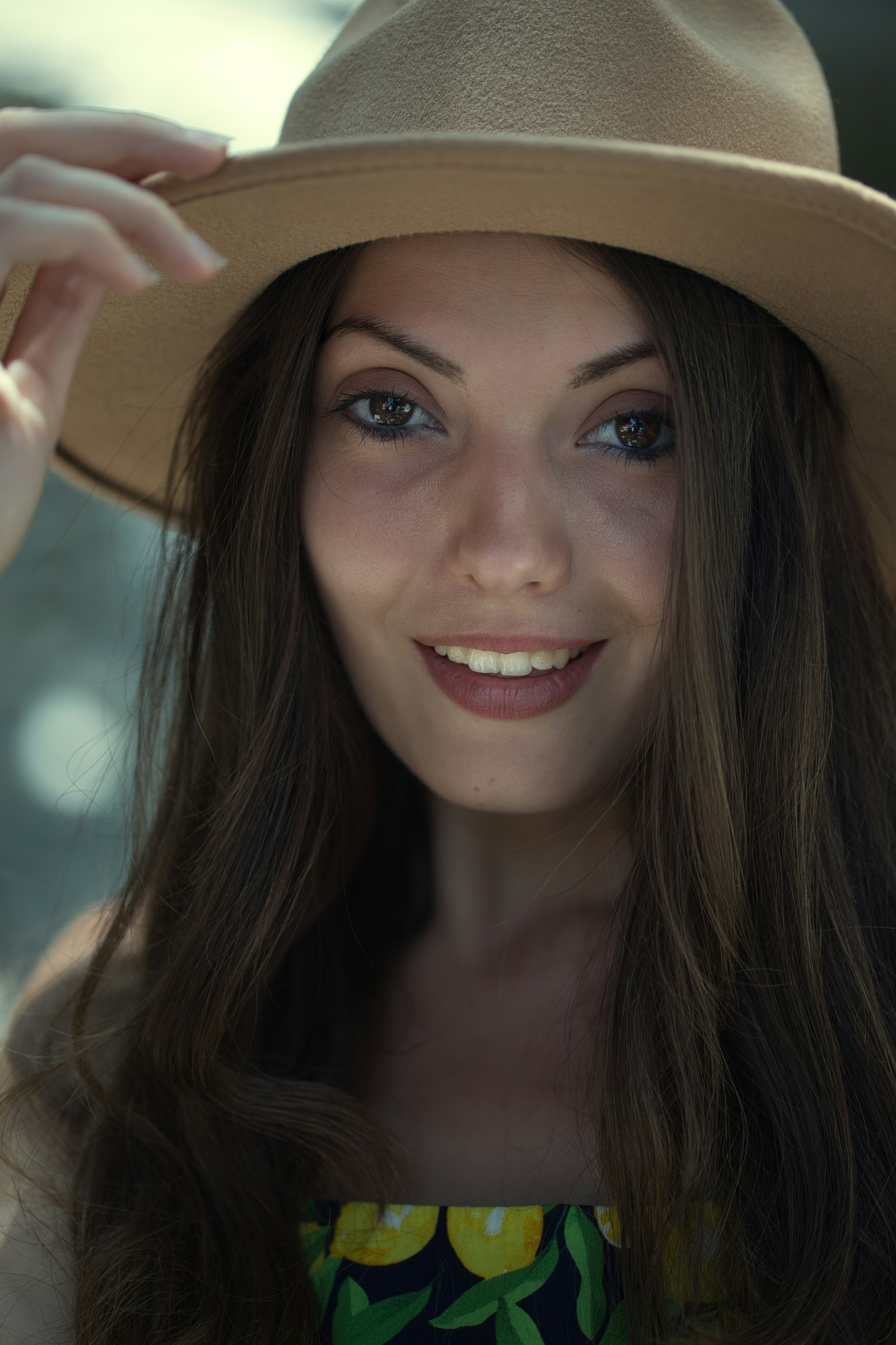 A woman wearing a hat and smiling for the camera