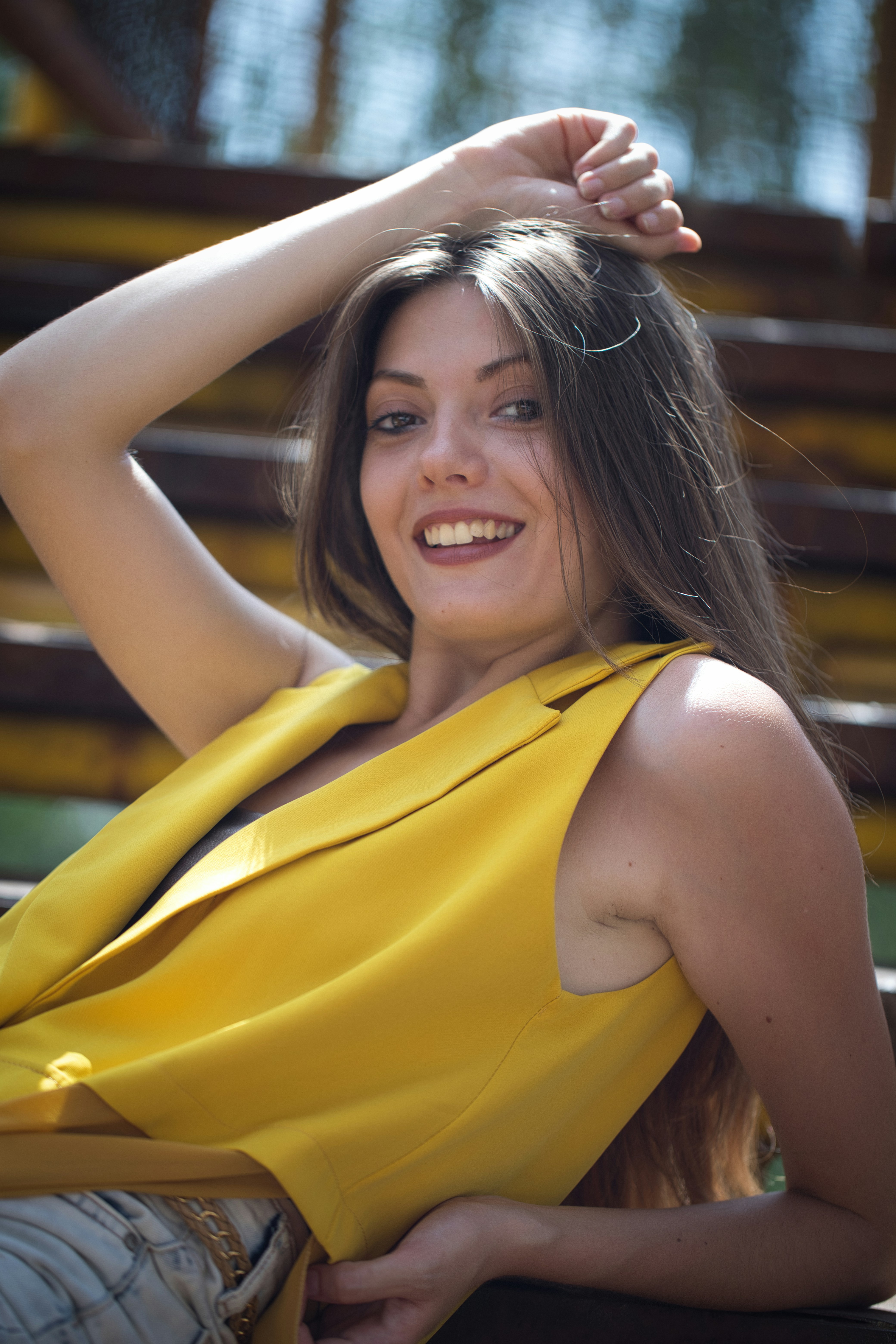 A woman in a yellow dress sitting on a bench