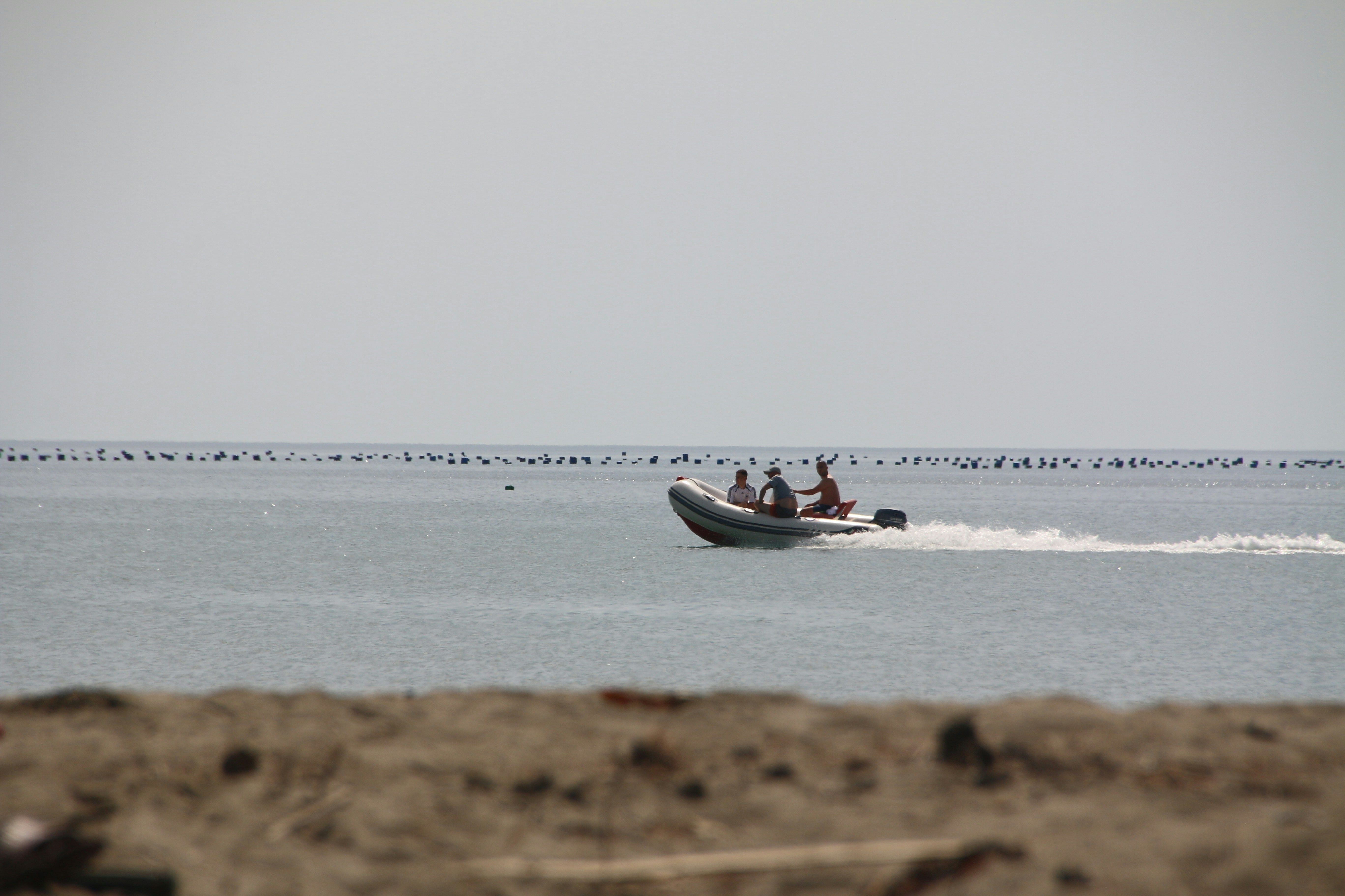 A small boat with two people on it in the water