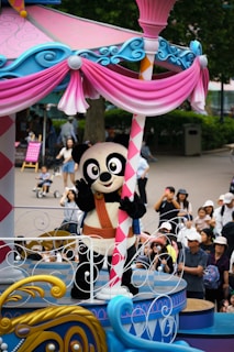 A parade float with a panda riding on top of it