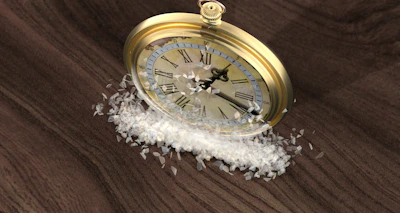 A gold clock sitting on top of a wooden table