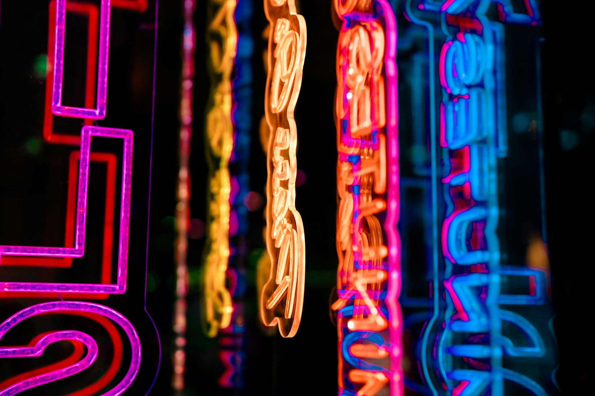 Neon signs are lit up in the dark