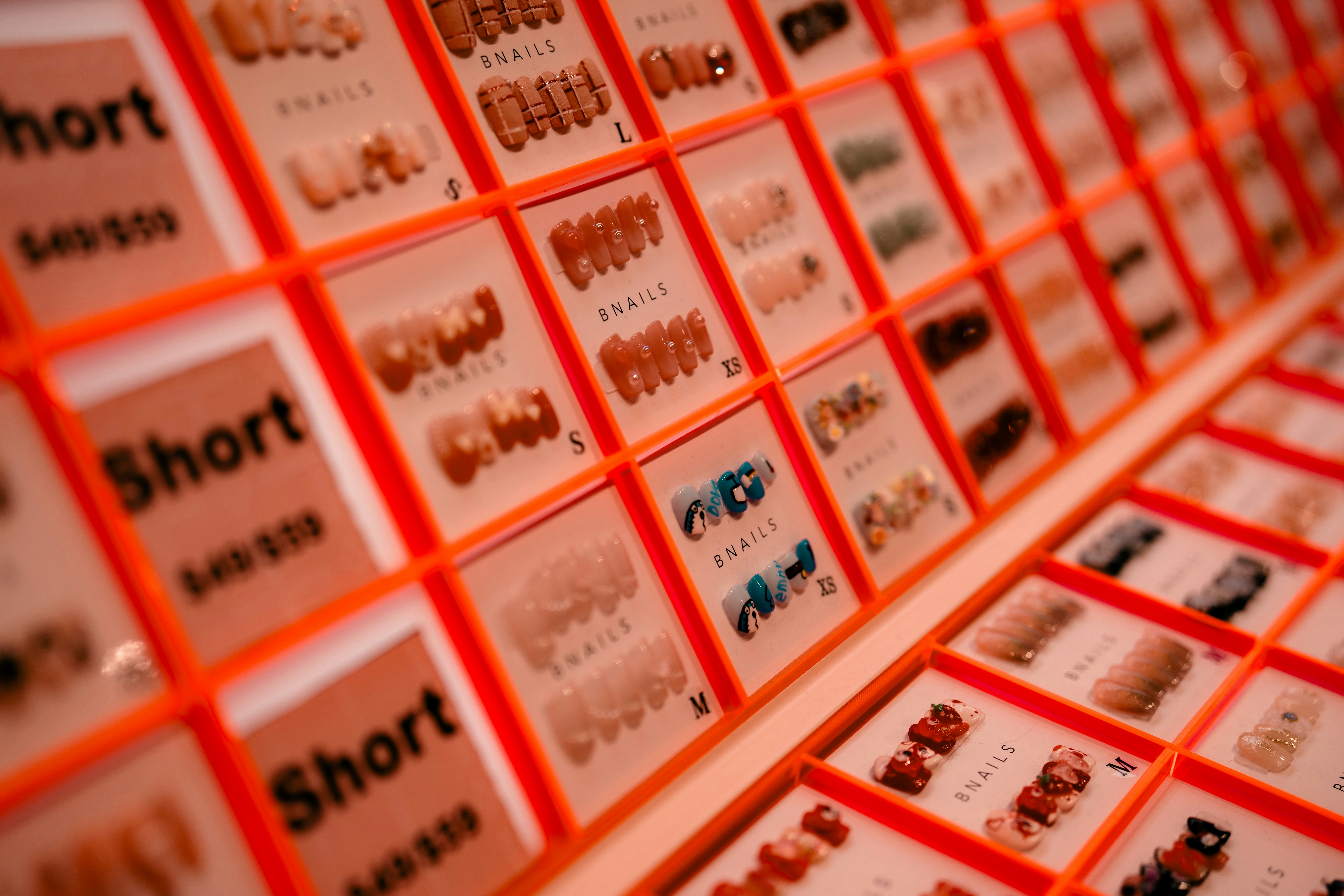 Rows of press-on nail kits in individual packages.