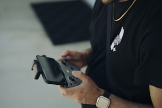 A man in a black shirt holding a cell phone