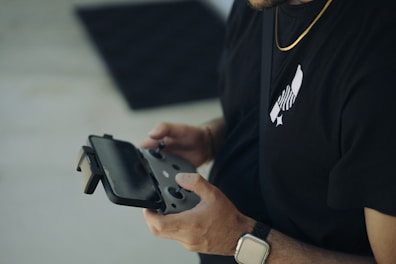 A man in a black shirt holding a cell phone