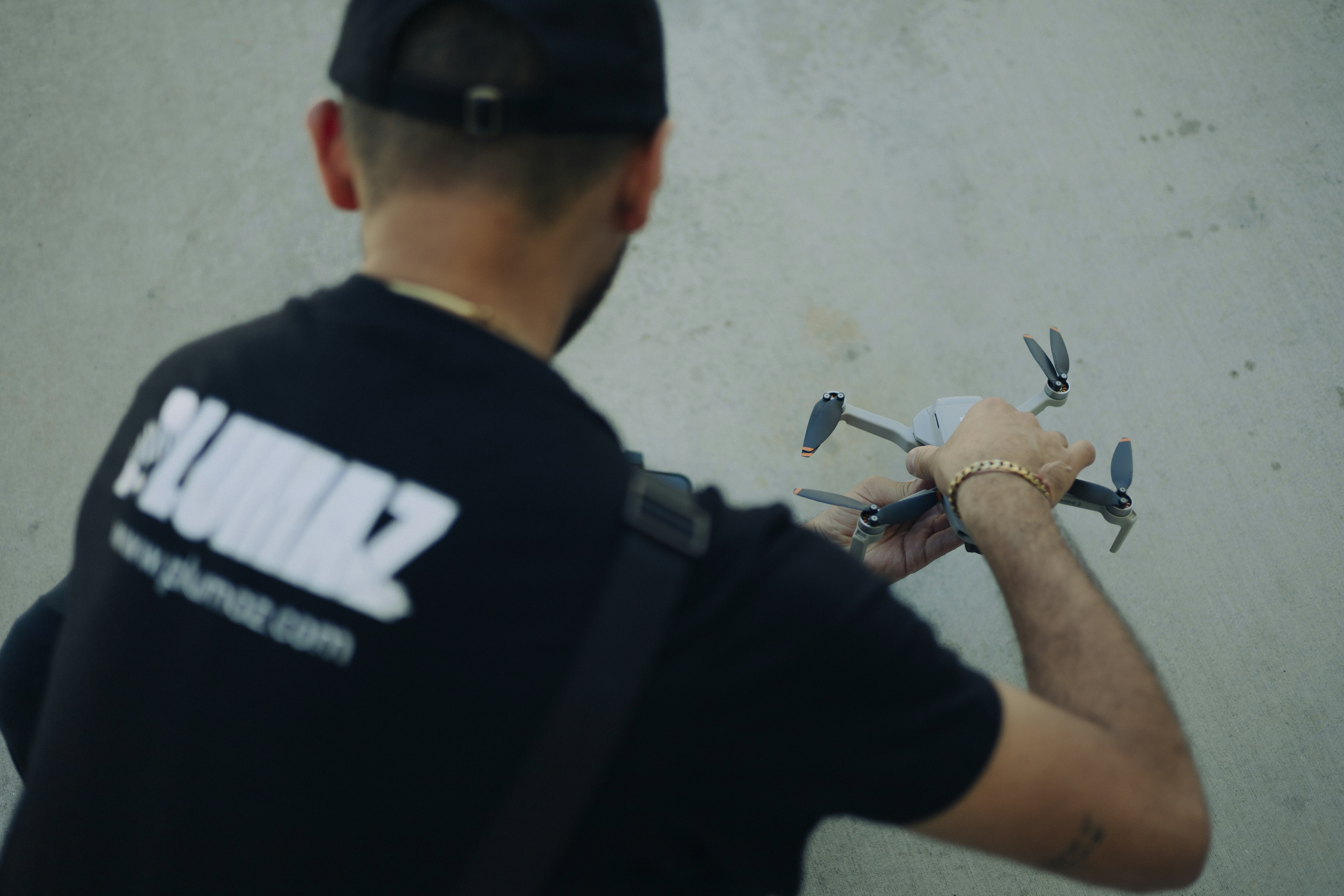 A man in a black shirt holding a pair of scissors