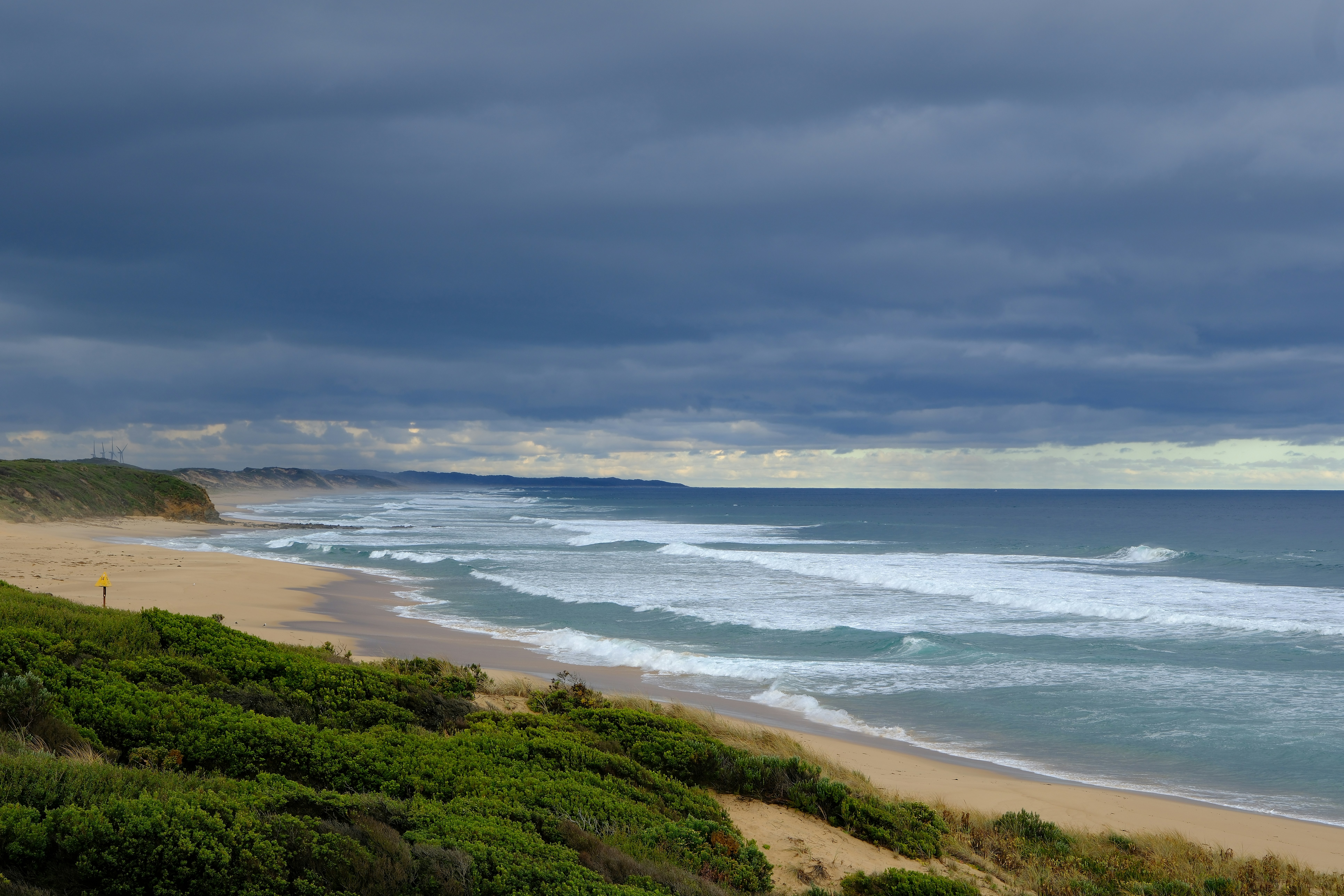 A calm coastal scene in Australia, perhaps with gentle waves and clear skies - how can you relax