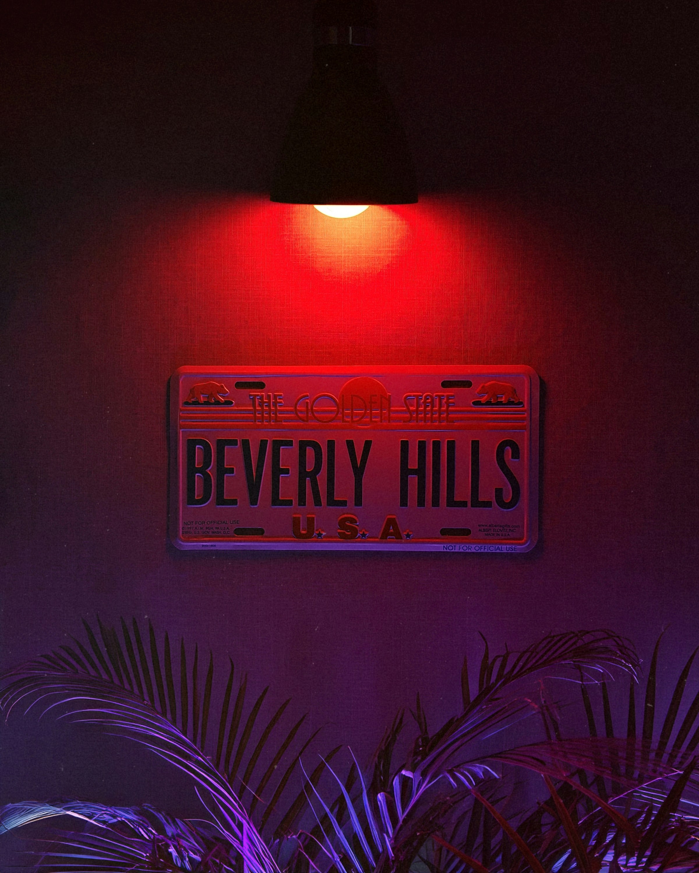 A red light shines on a sign that reads beverly hills usa