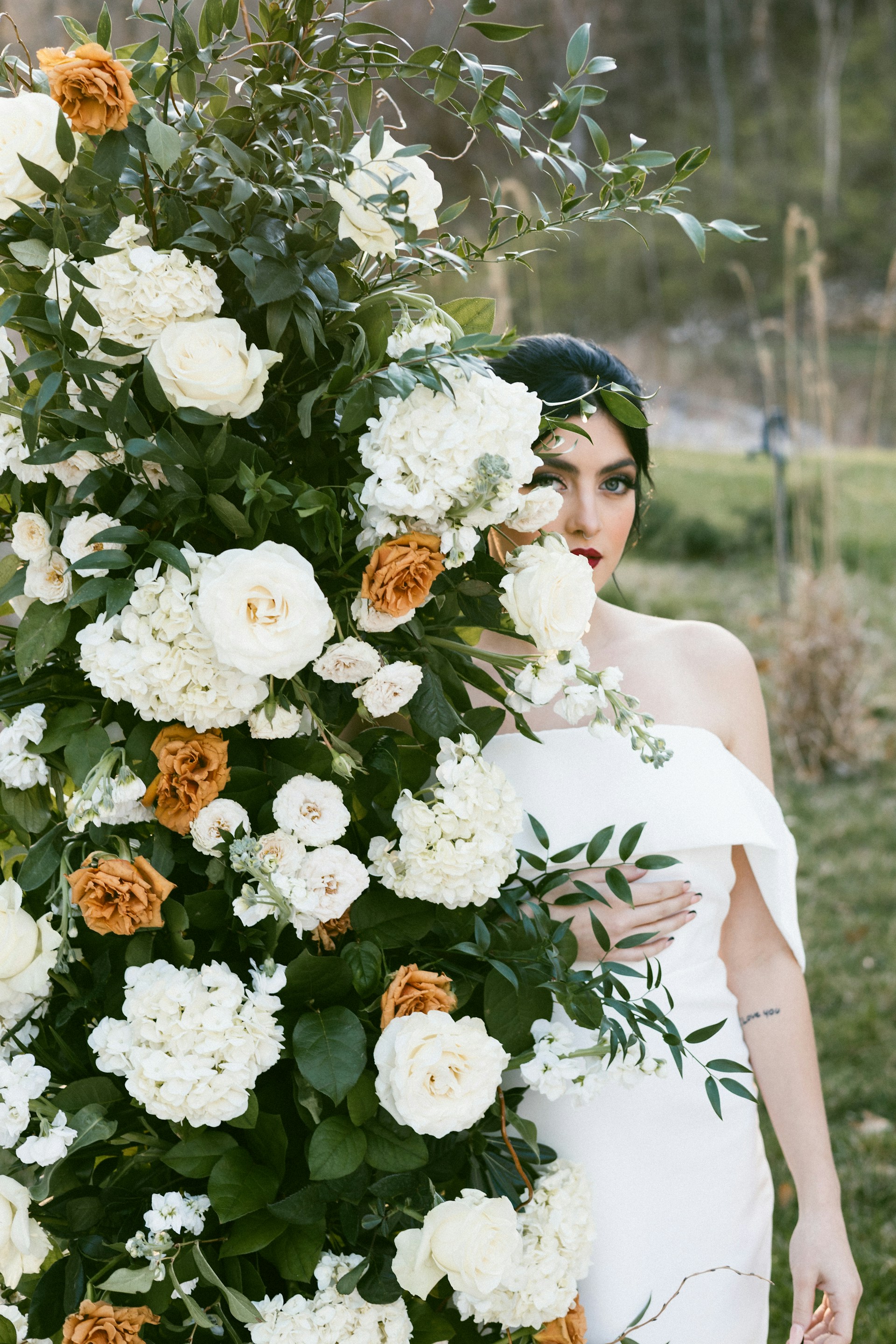 A woman in a white dress holding a bouquet of flowers