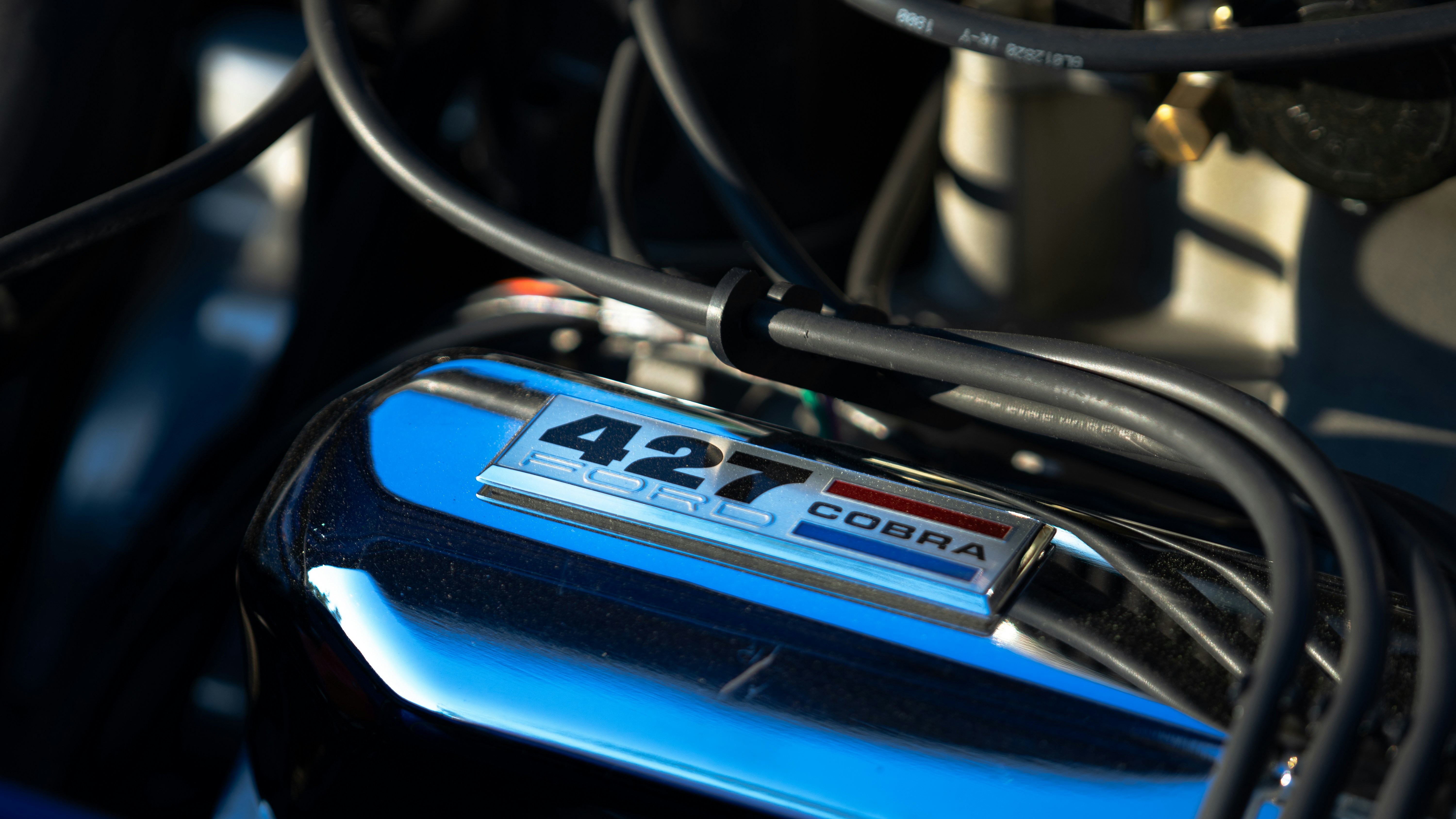 Technician performing diagnostic test on a hybrid car battery pack in a service bay