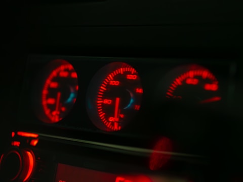 A car dashboard with red and blue lights