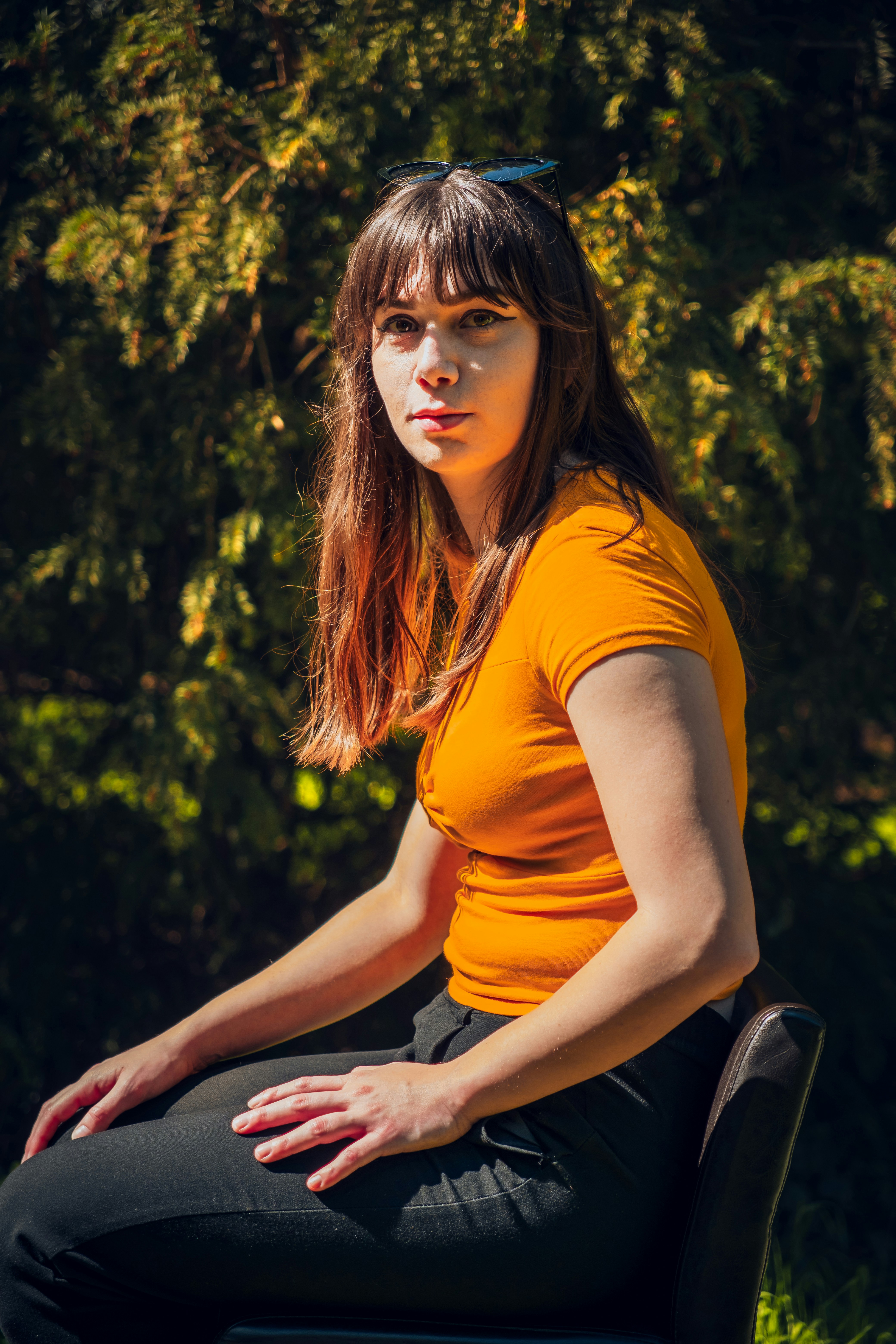 A woman sitting on top of a black chair