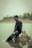 A man sitting on a rock in the water