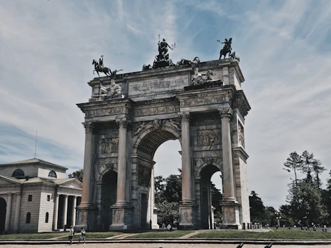 A large stone arch with statues on top of it