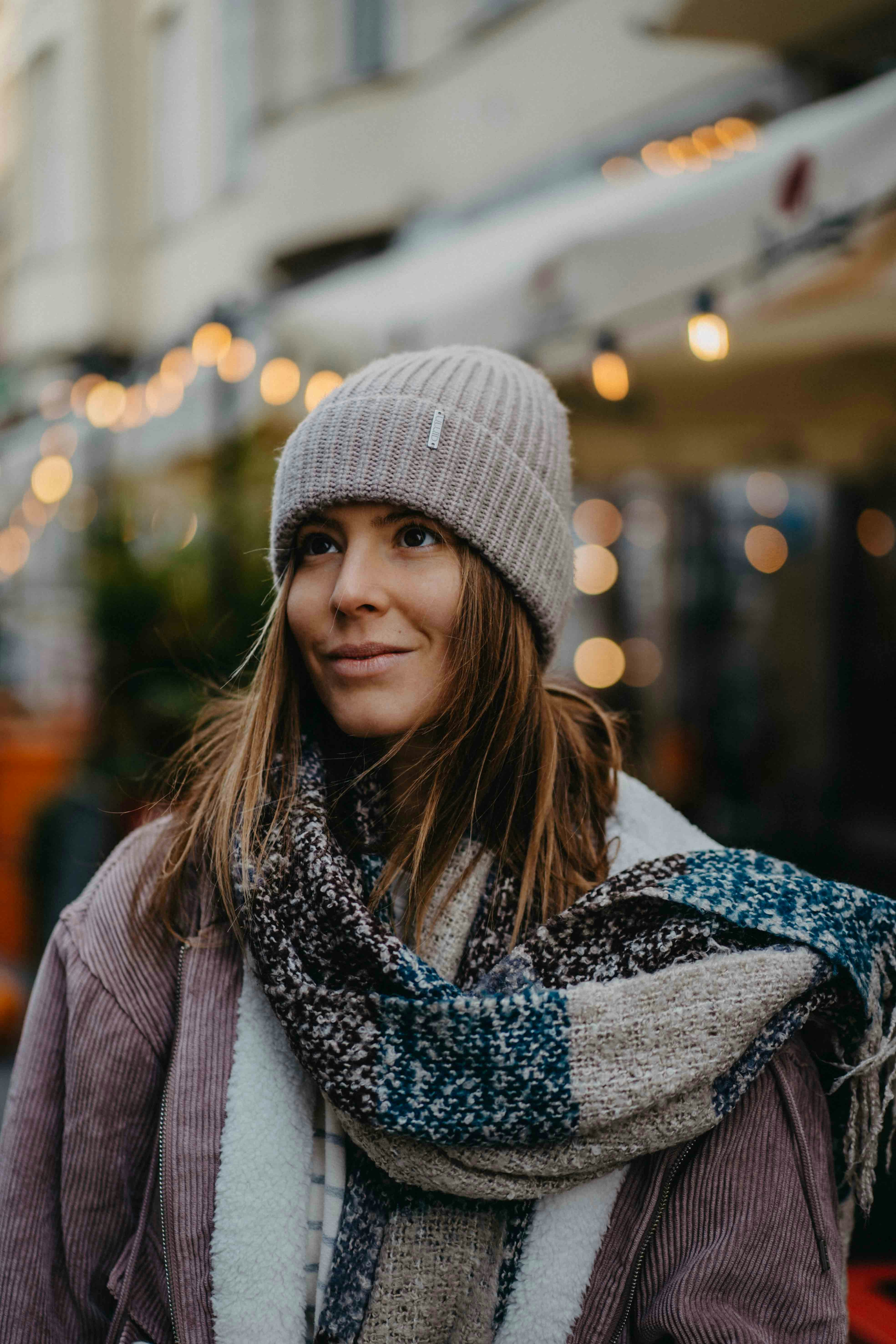 A woman wearing a scarf and a hat