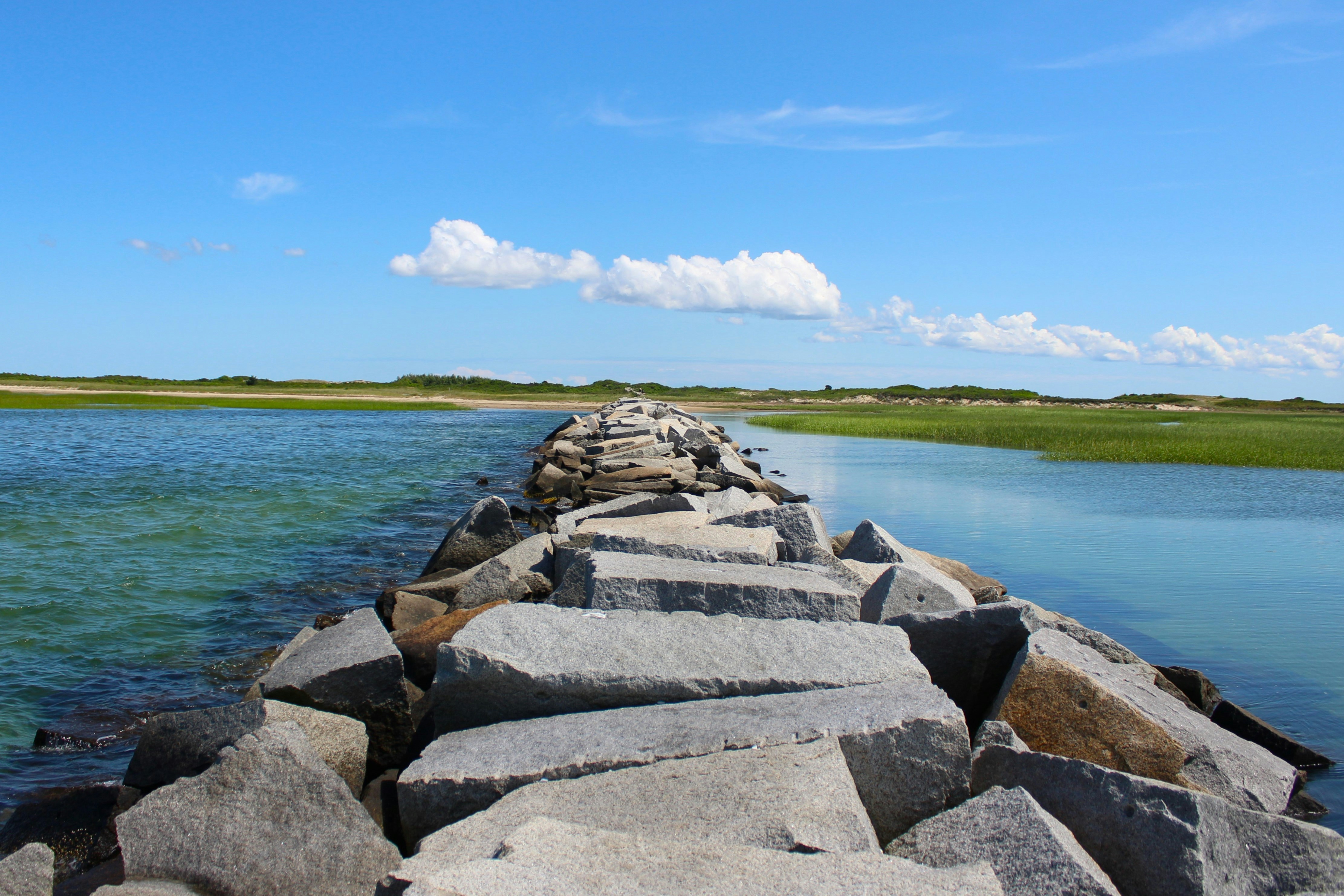 A large body of water sitting next to a stone wall