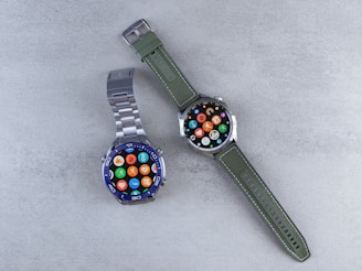 A couple of watches sitting on top of a table
