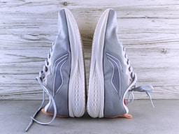 A pair of gray sneakers with white laces