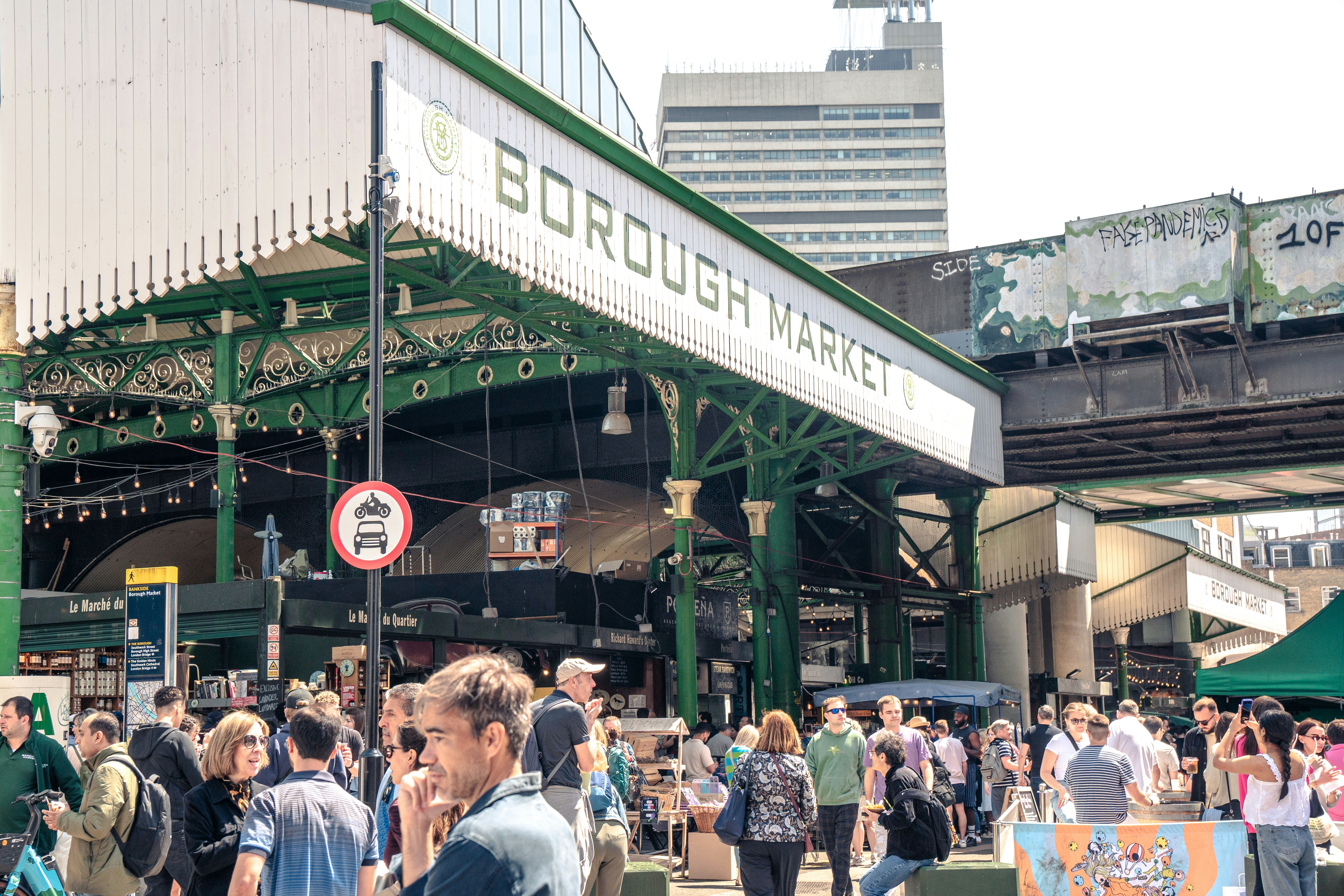 A crowd of people walking around a train station