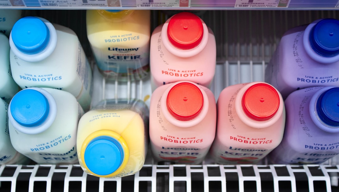A refrigerator filled with lots of different colored bottles