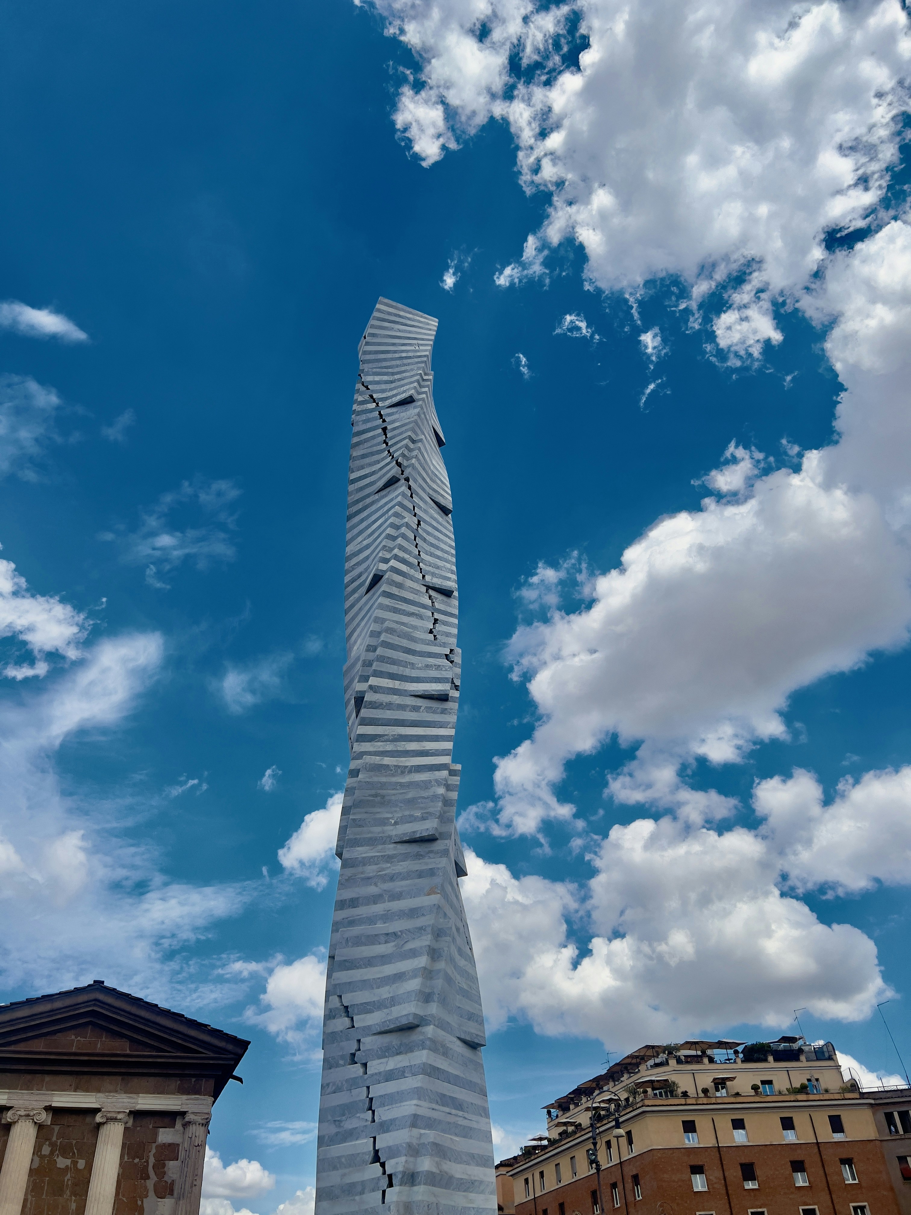 A very tall building with a very tall tower in the middle of it