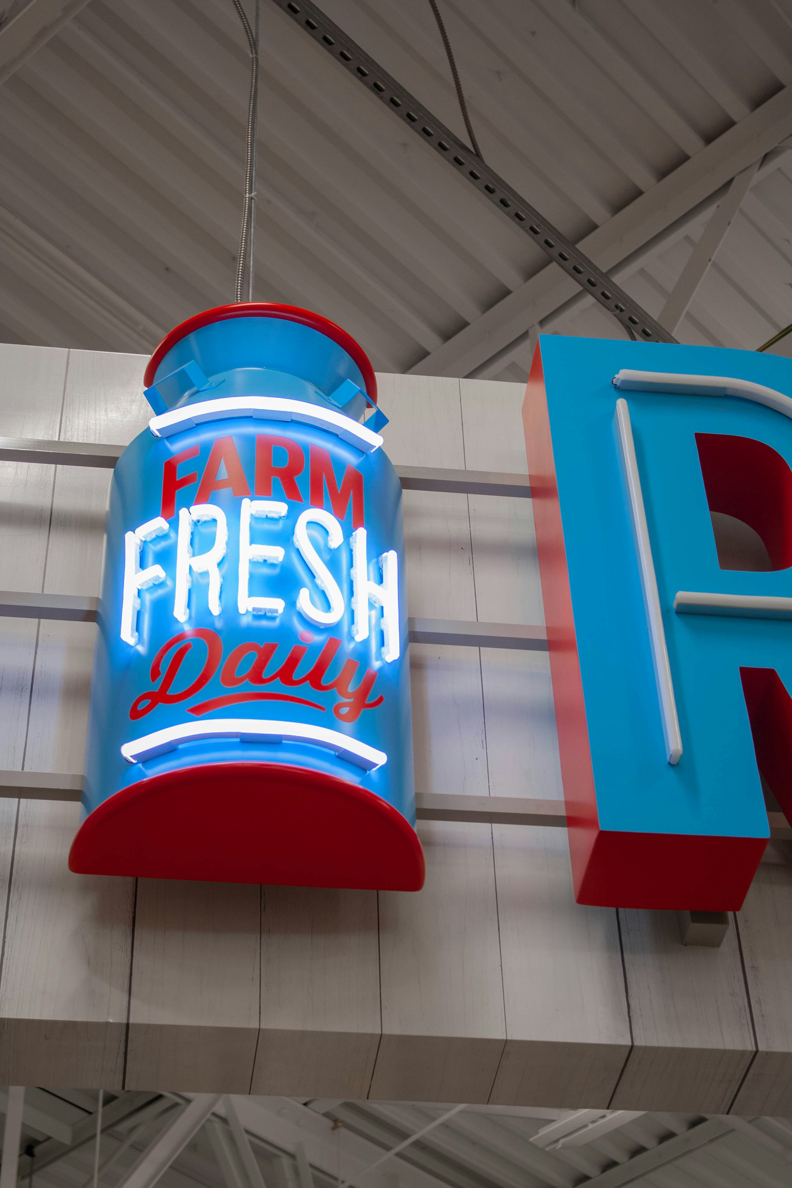 A large neon sign hanging from the side of a building