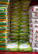 A grocery cart filled with lots of bags of food