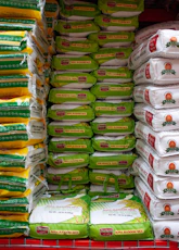 A grocery cart filled with lots of bags of food