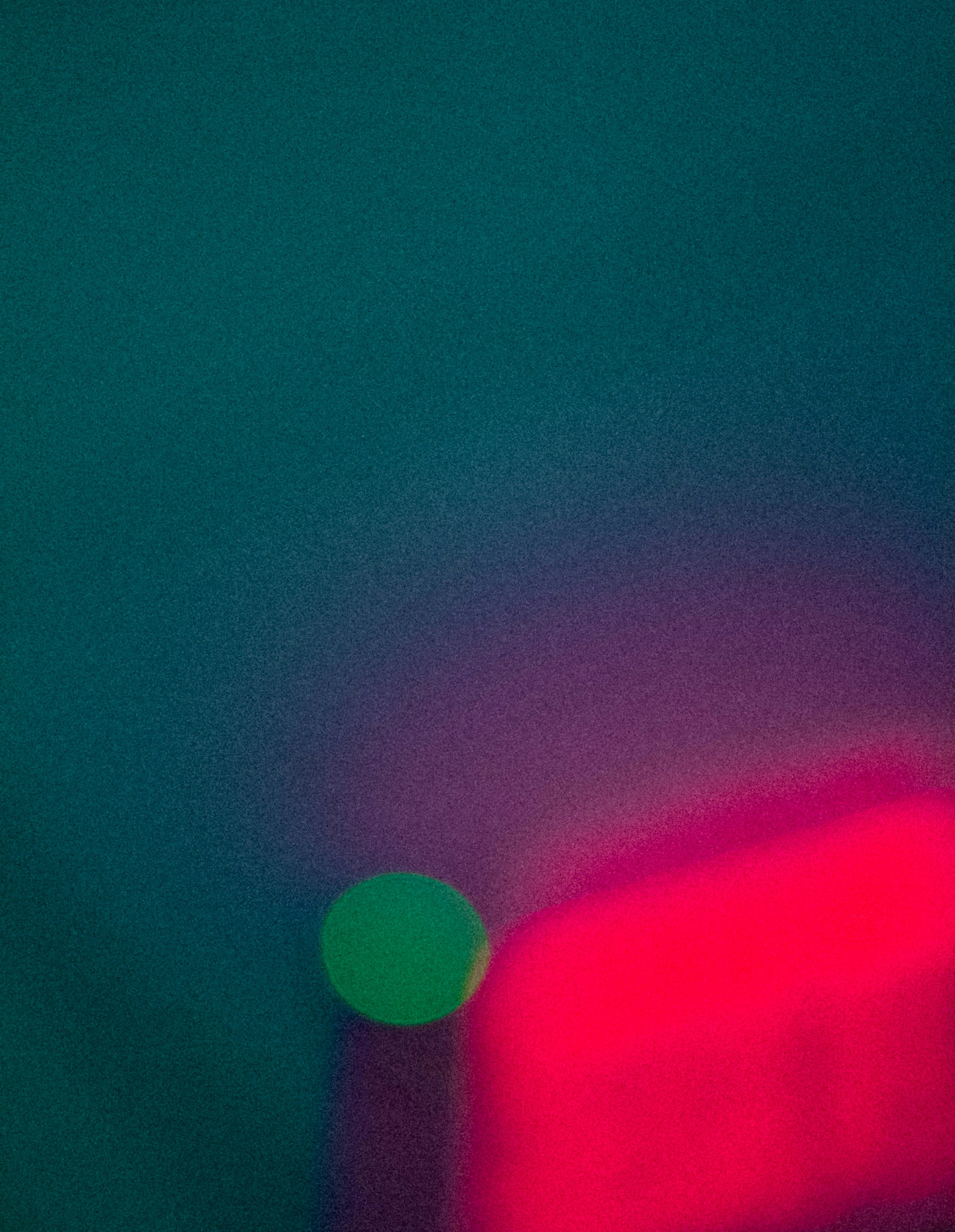 A blurry photo of a red and green object