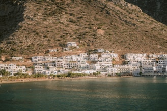 A large body of water next to a mountain