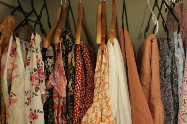 A rack of clothing hanging on a wall