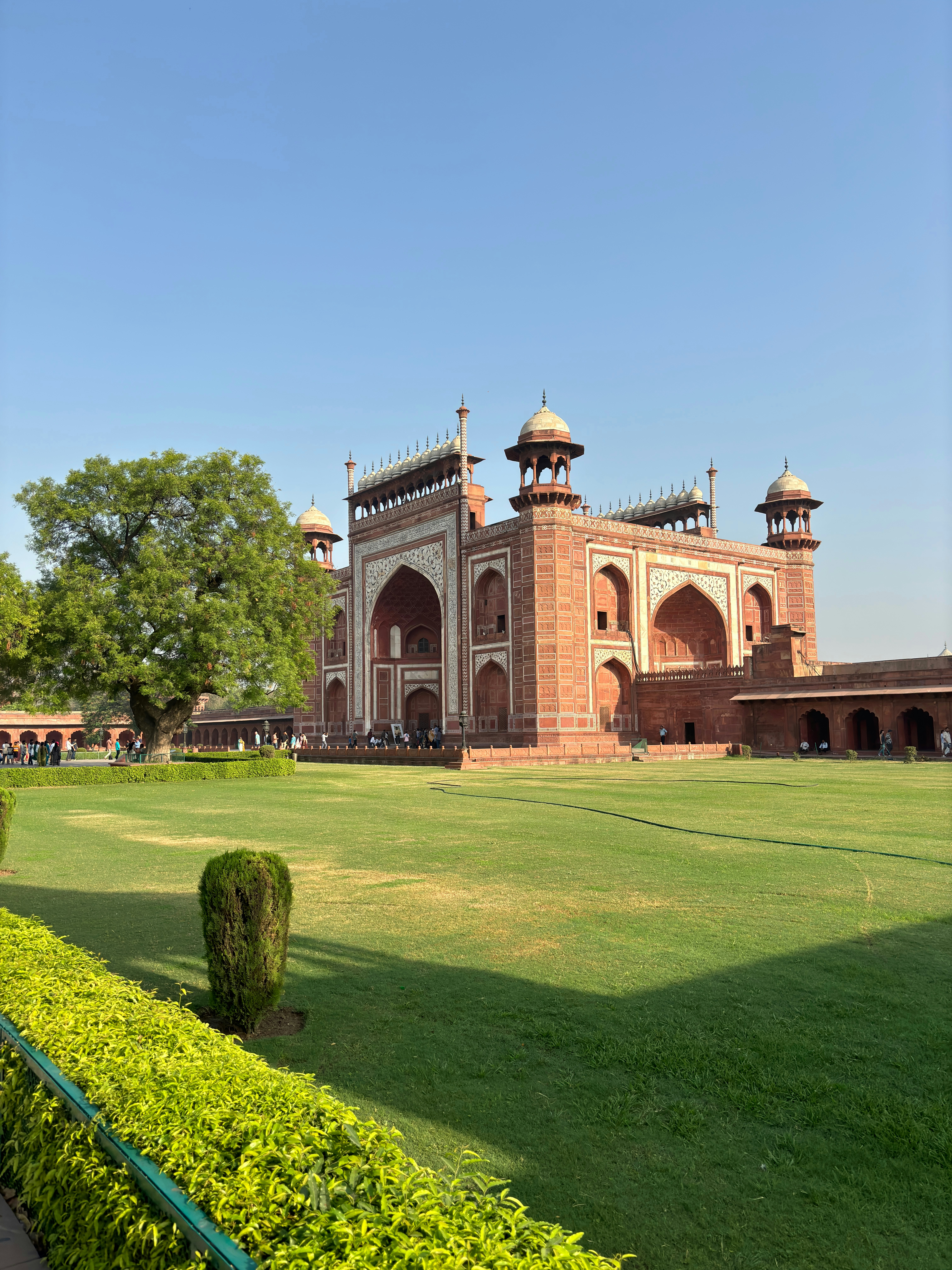 A view of a large building with a lawn in front of it