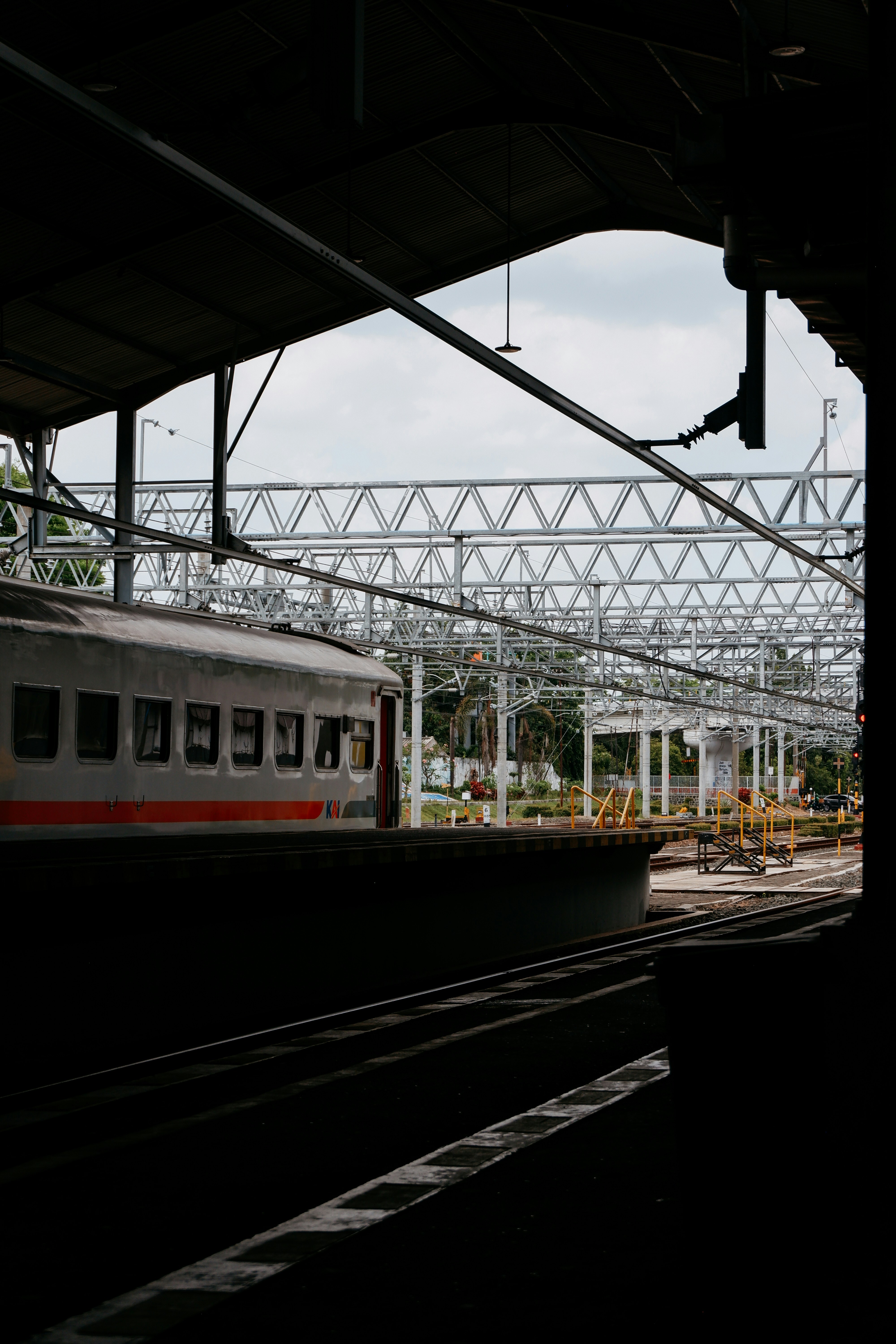 A train traveling down train tracks next to a train station