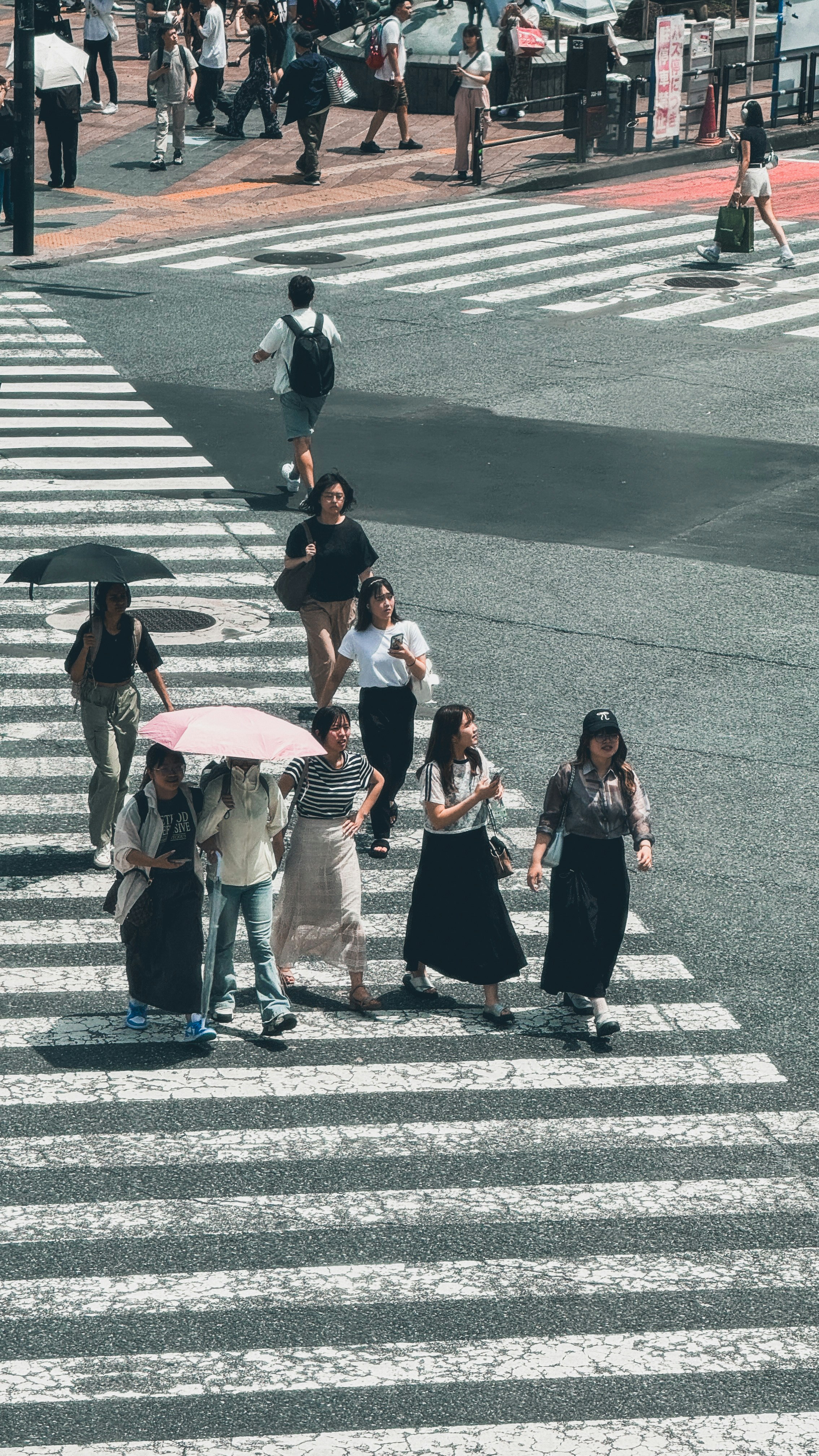 A group of people walking across a cross walk