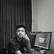 A man sitting in front of a computer monitor