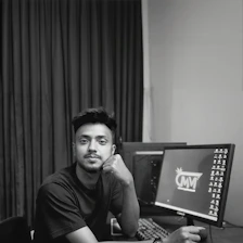 A man sitting in front of a computer monitor