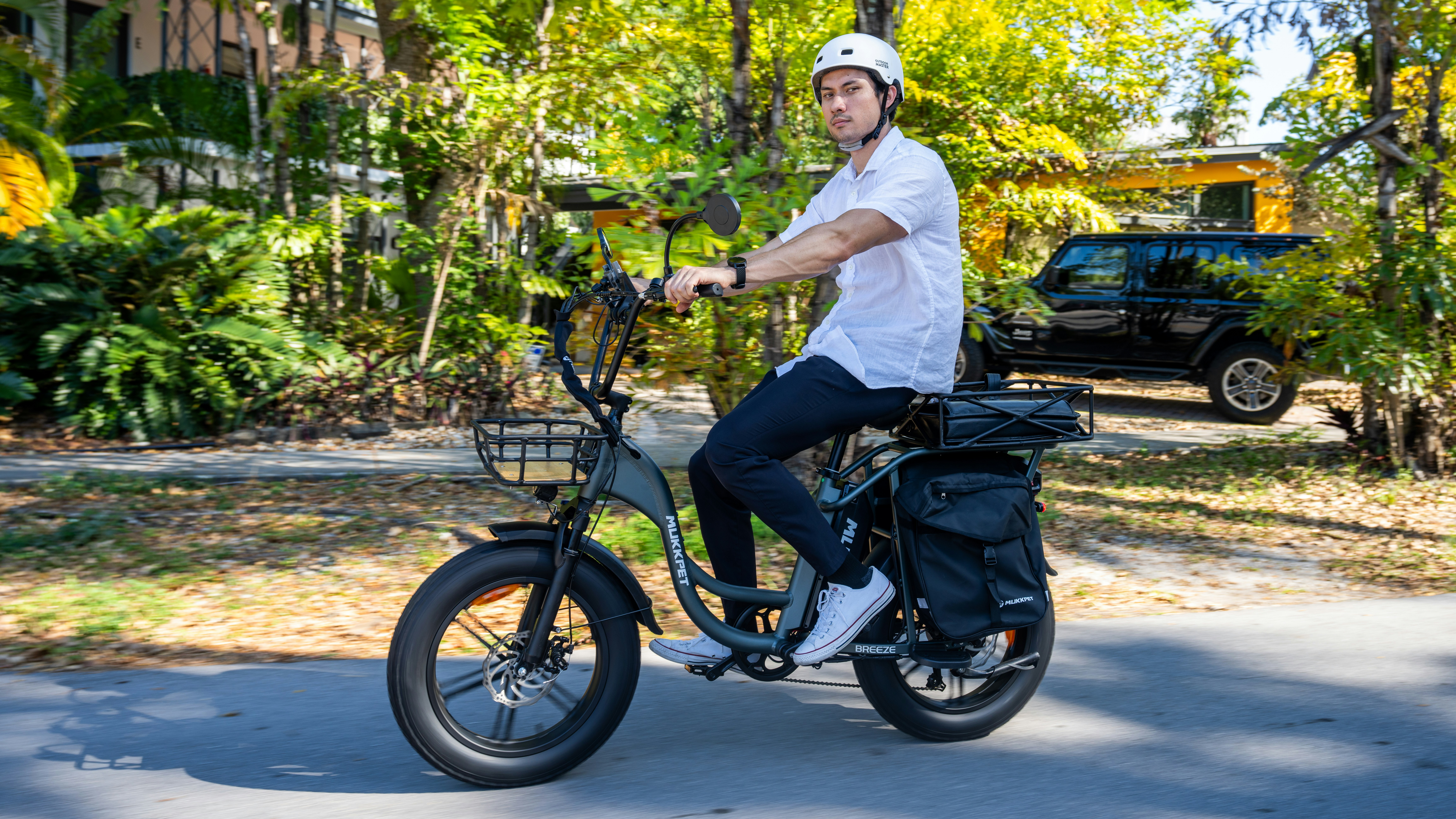 A man riding a bike down a street photo – Free Outdoor Image on Unsplash