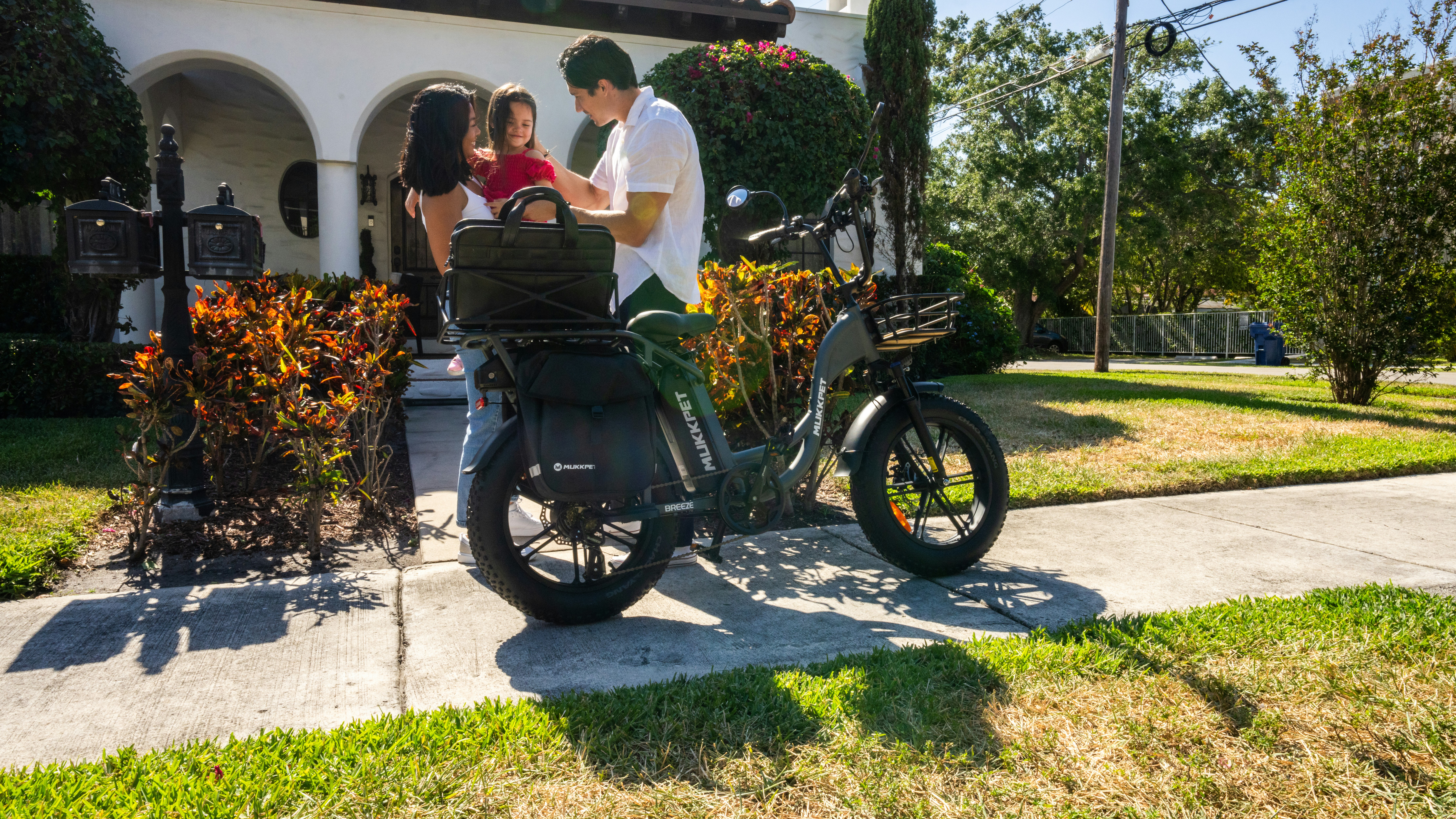 A man and a woman standing next to a motorcycle