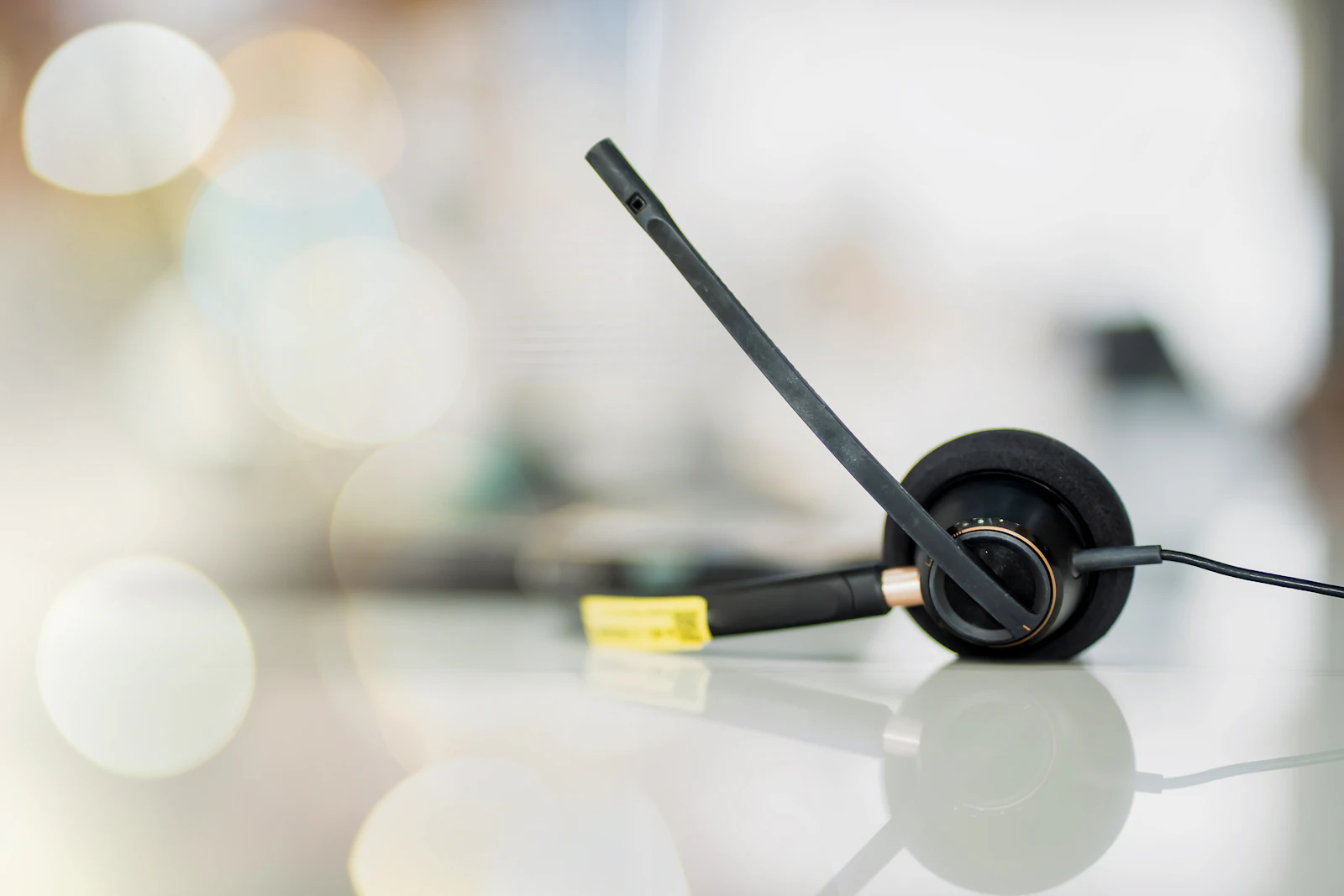 A support headset resting on a bright, clean desk